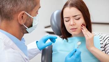 woman with toothache talking to her dentist 