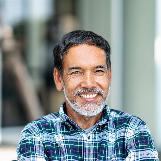Middle-aged man smiling with dental implants in Evergreen