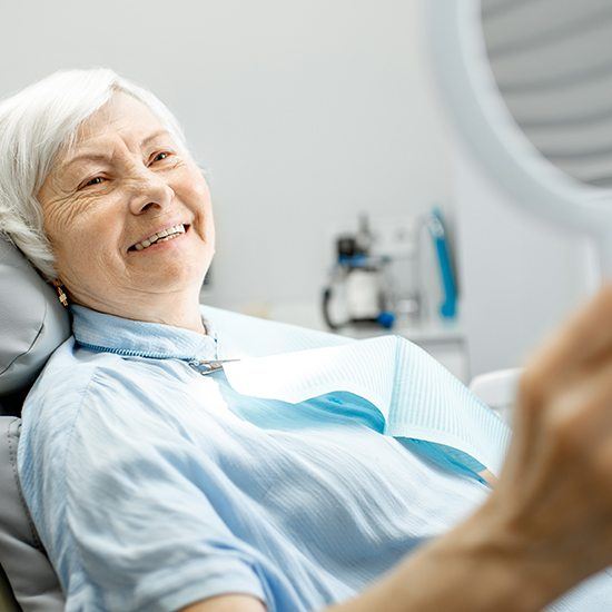 older woman smiling in chair