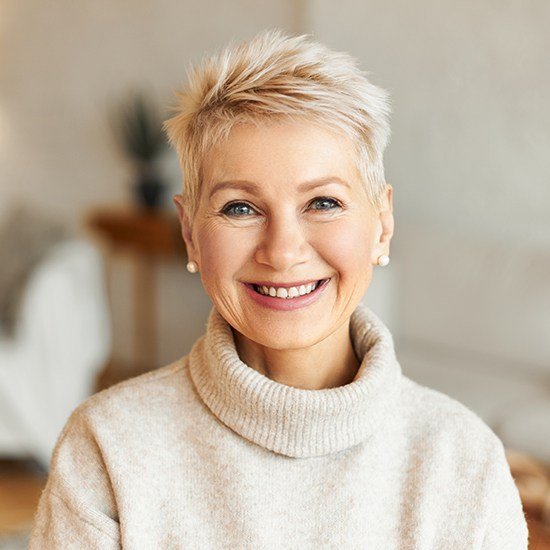 woman smiling in turleneck sweater