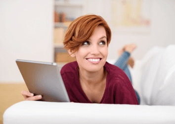girl smiling holding ipad