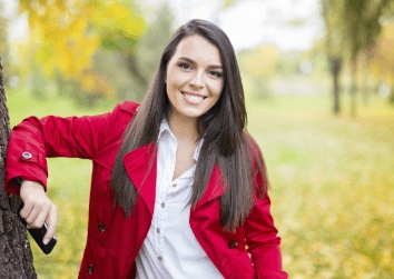girl smiling by tree