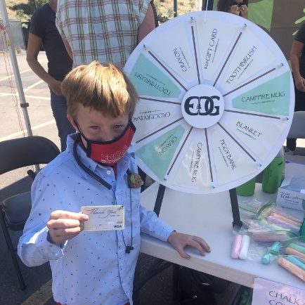 boy with thank you card and prize wheel