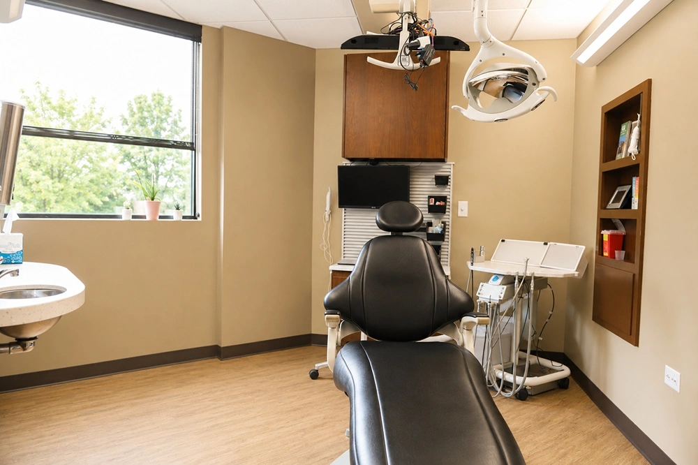 Clean dental operatory with overhead light and patient chair