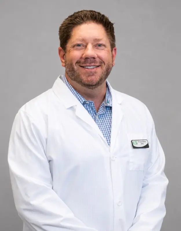 Dr. Scott Gordon, dentist at Evergreen dental practice in Colorado, smiling professionally.